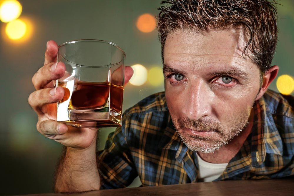A man's alcoholic looks painful